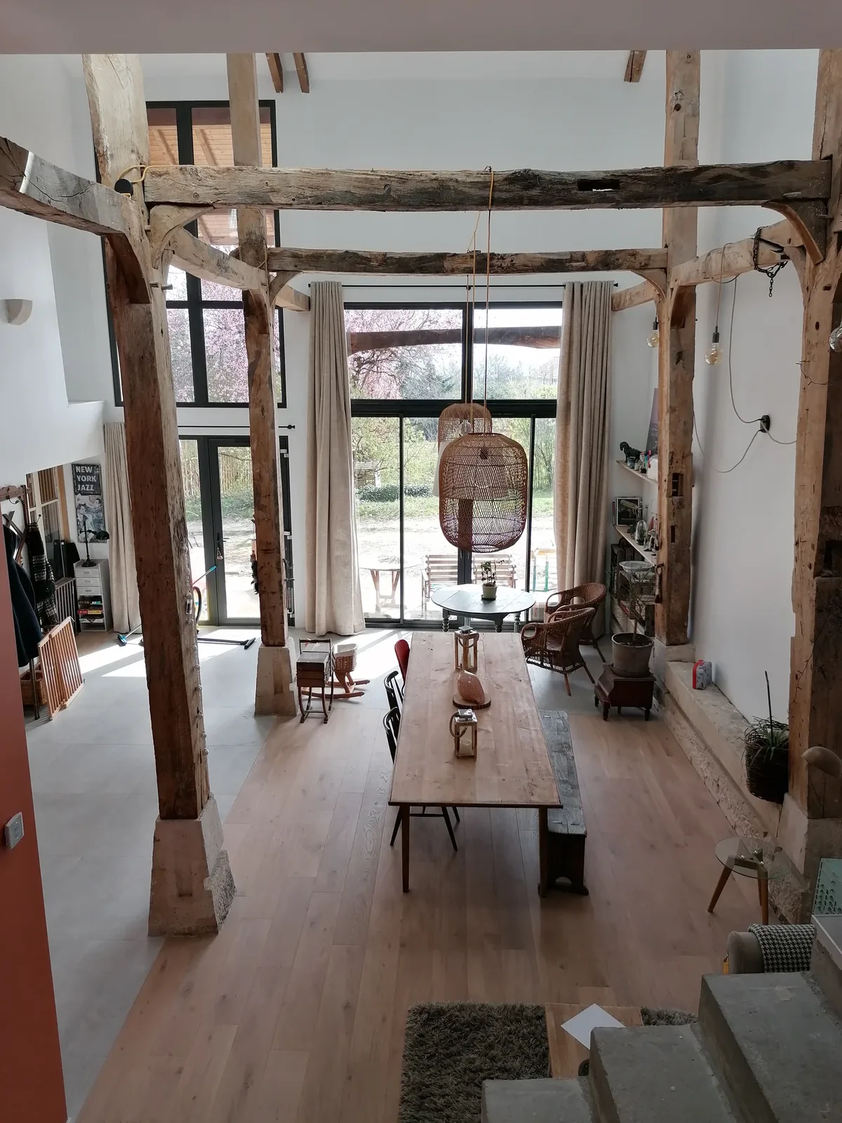 Salle à manger sous la charpente, baies vitrées au fond — La grange, Echenevex